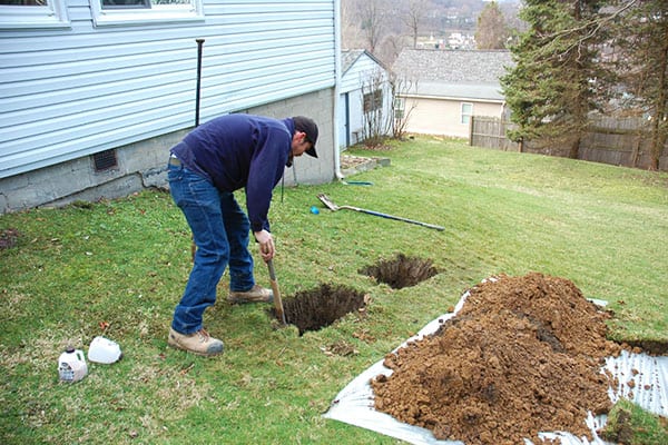 D-Bug Waterproofing digging to install wall anchors