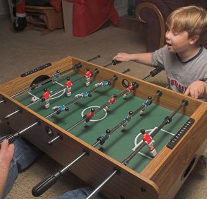 Foosball in a basement game room